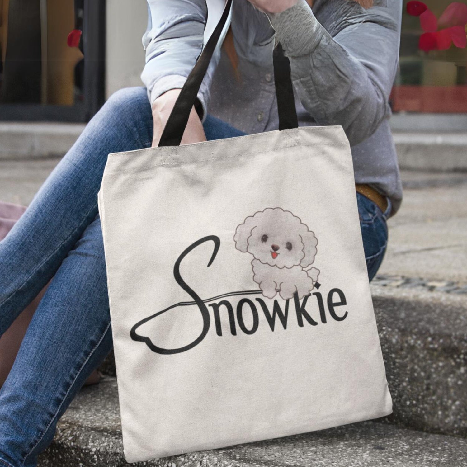 The Snowkie Tote Bag with a Woman placing her hand in the bag