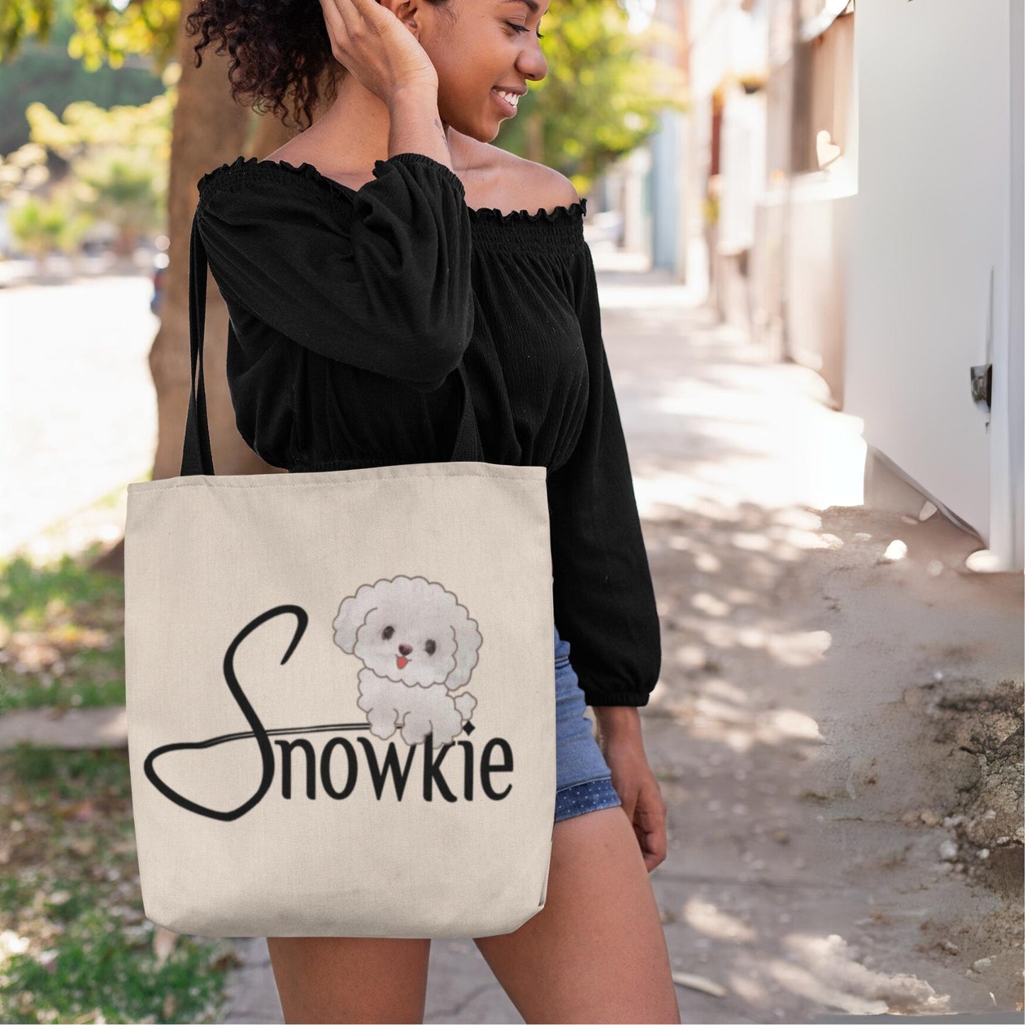 The Snowkie Tote Bag with a woman touching her hair